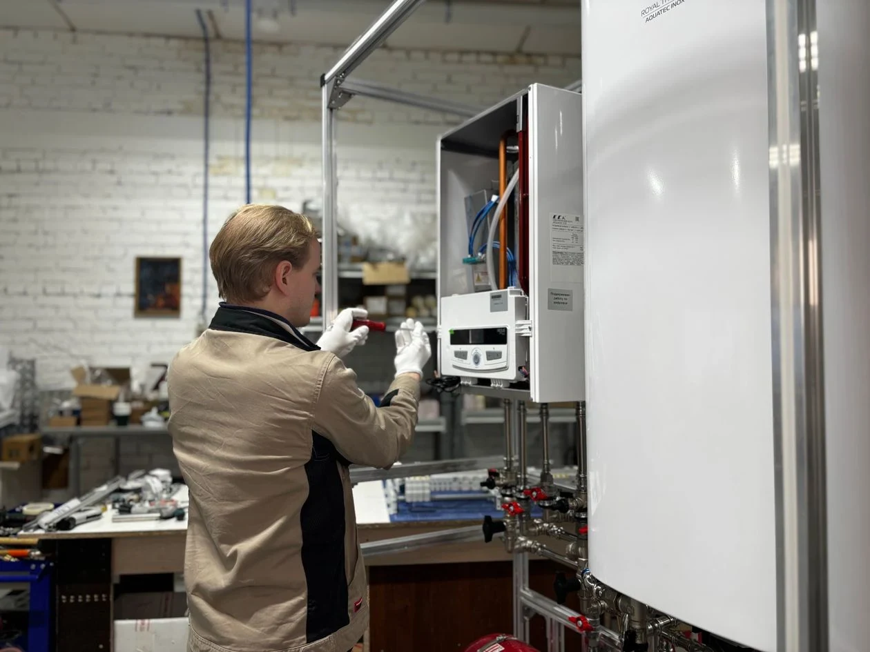 Technician installing a new water heater in a utility room