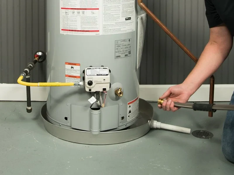Hose connected to a water heater drain valve to empty the tank